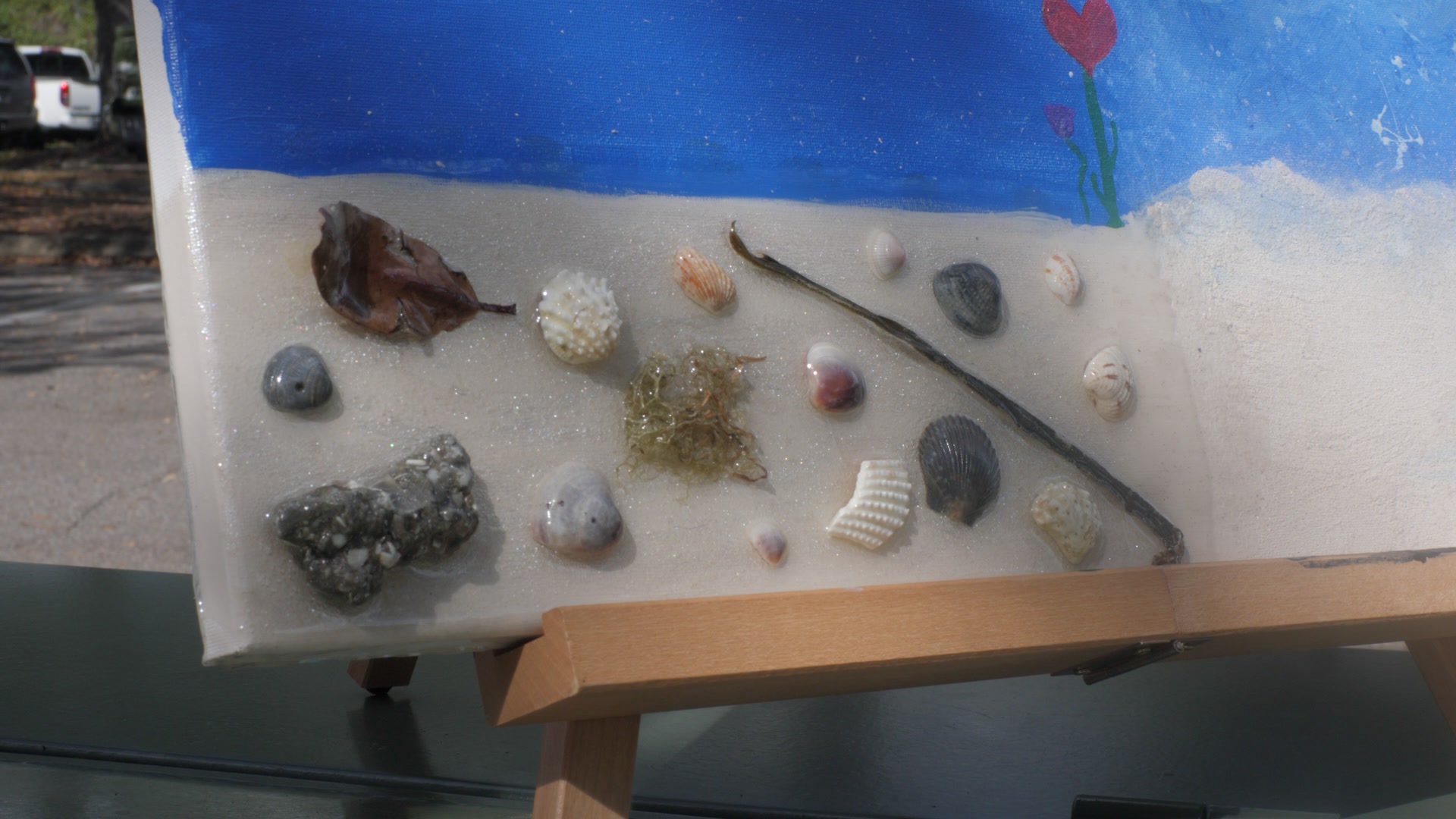 Sand, shells, seaweed, and stones — gathered from the beach and sealed in the painting forever